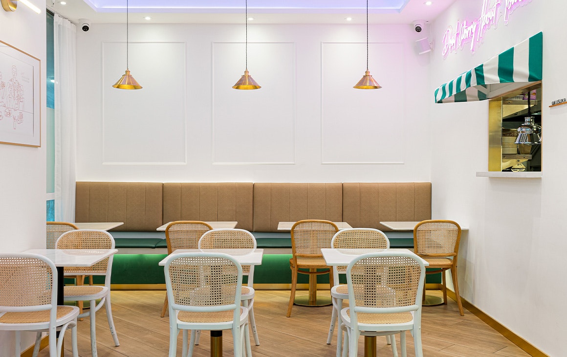 the dining area at kasuka, with banquette seating and wicker chairs